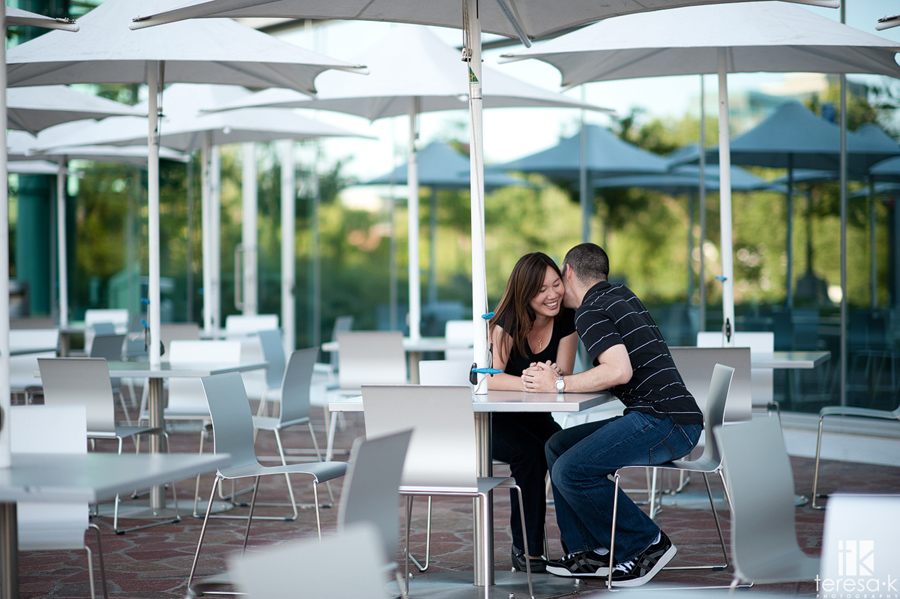  Cute picture of couple interacting under an umbrella at the CalStrs building 