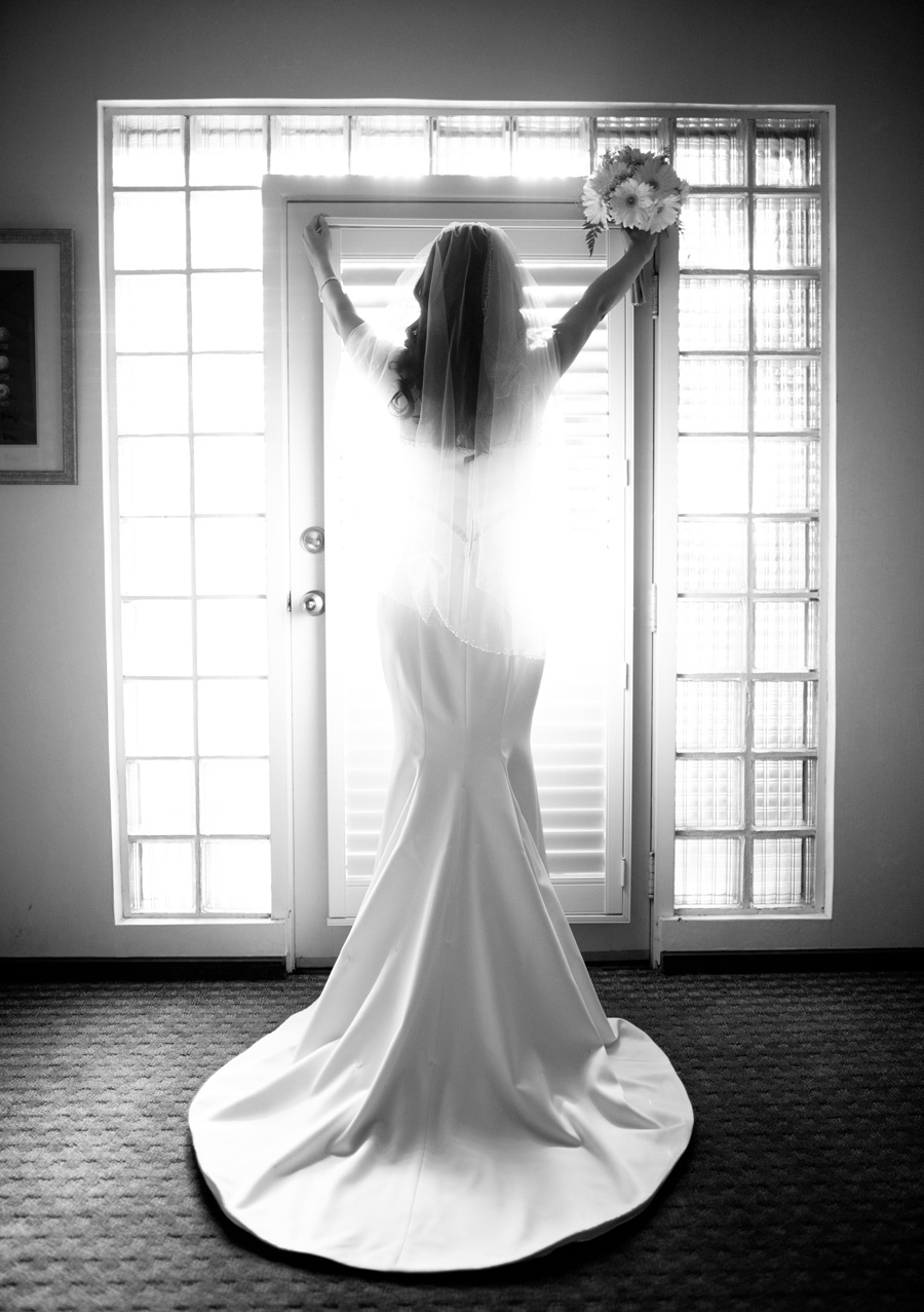 beautiful backlit picture of brides dress by a window
