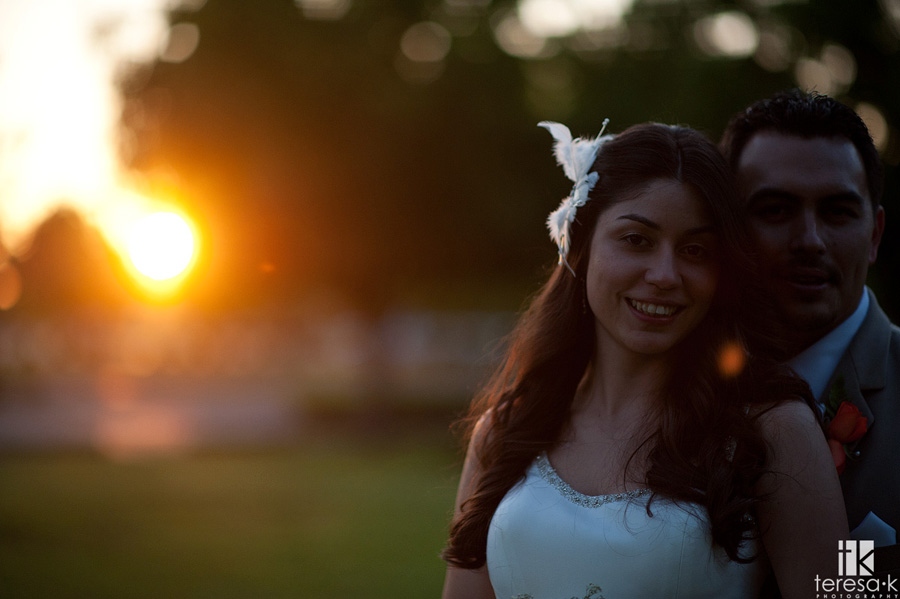 strongly backlit photograph of bride and groom at McClellan afb wedding