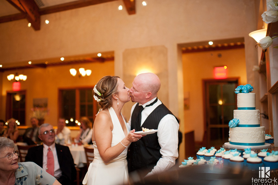 bride and groom kiss after the cake