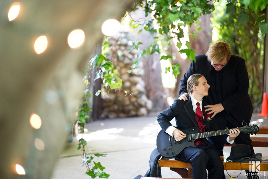bride's son plays guitar at wedding