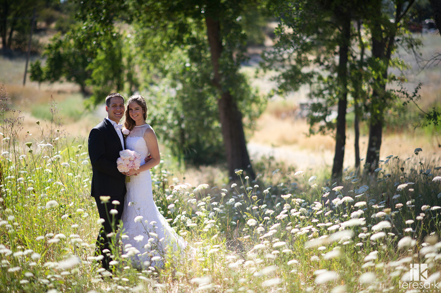 bride and groom in beautiful flowers outside at wedding