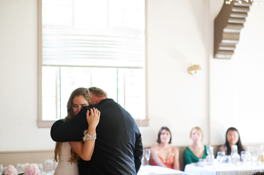 Dad hugs daughter after wedding reception dance