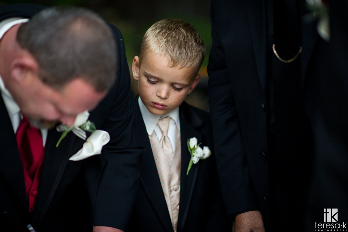 young ring bearer watches marriage signing