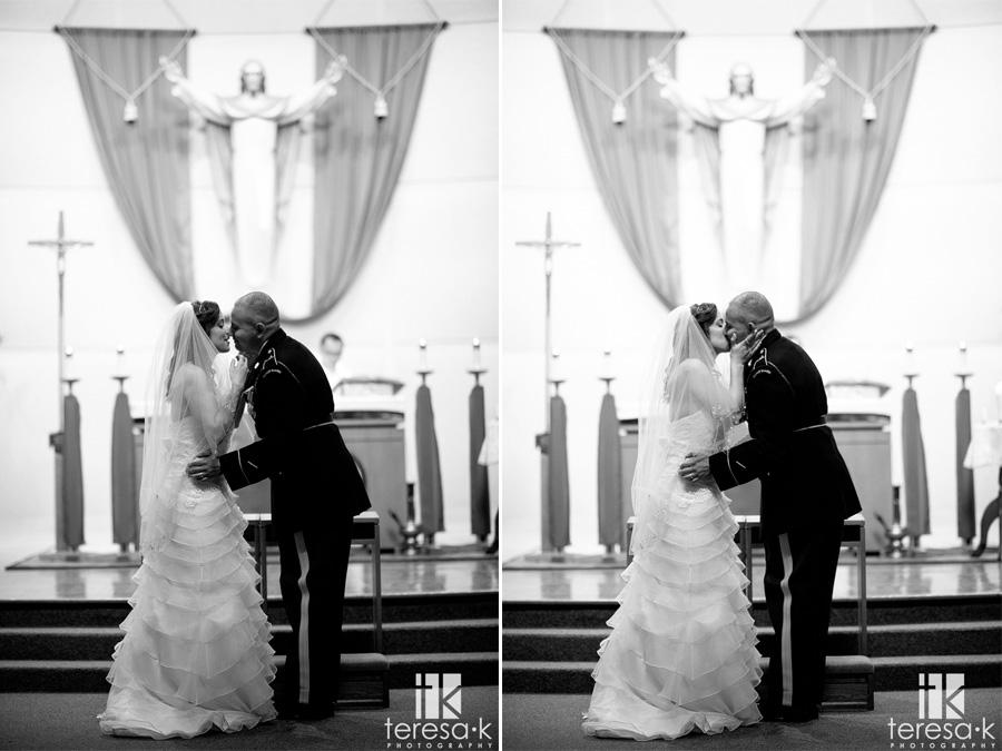 bride and groom kiss on the alter