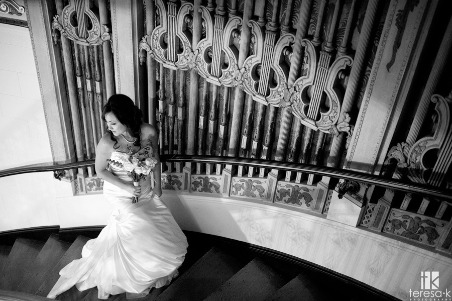 bride on the staircase at the grand island mansion