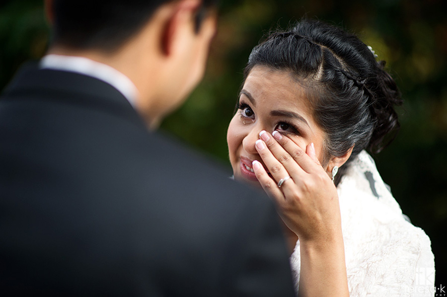 bride wipes tear at Oakland wedding first look