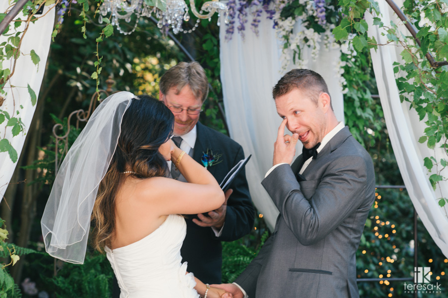 bride and groom wipe tears at same time